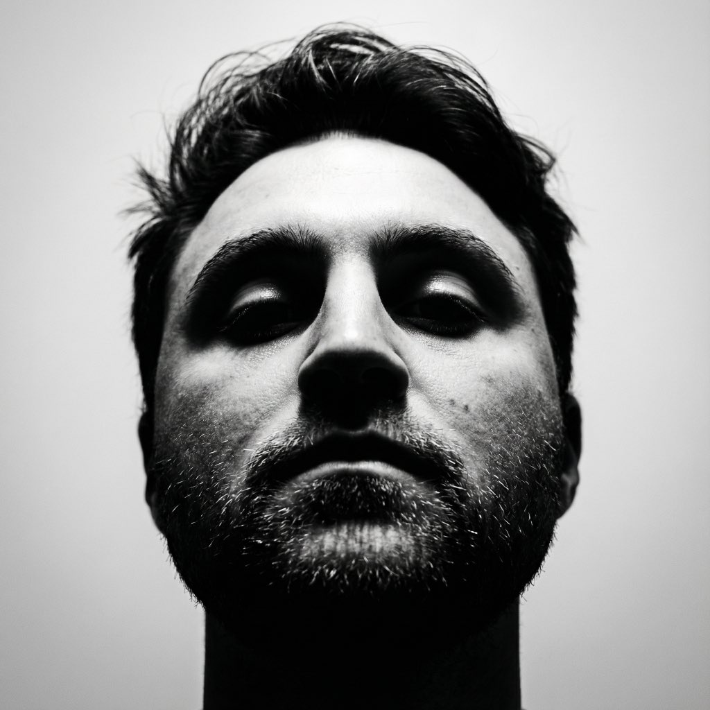 Mysterious Power Silhouette: Black and White Portrait of a Man with Wavy Hair and Rough Beard - AI generated image